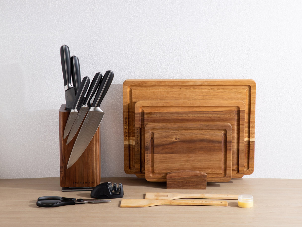 BAUER & MEYER Chef's Choice Collection: messenblok met zwarte messen naast acaciahouten snijplanken in houder